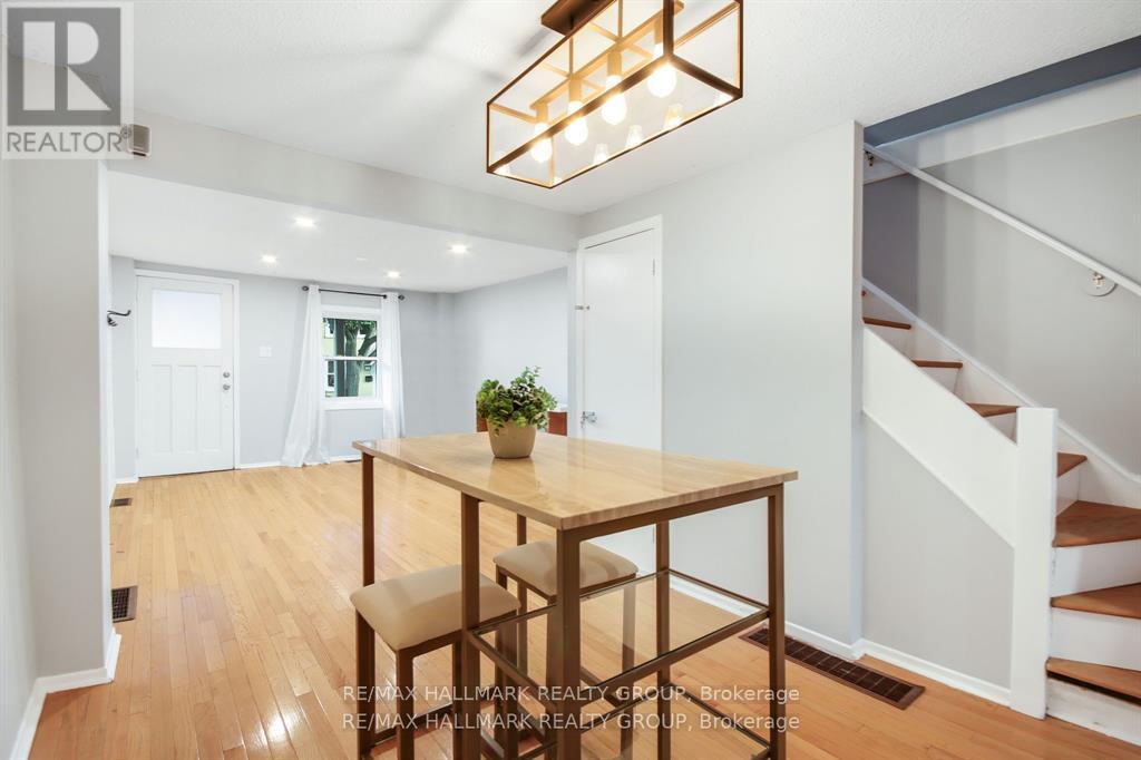 A dining room with a wooden table and chairs.