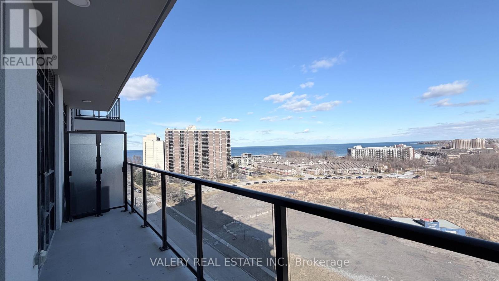 A balcony overlooks a construction site with buildings in the distance.