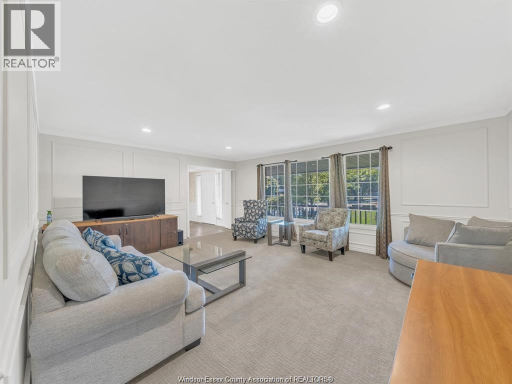 A living room with a grey couch and a glass coffee table.