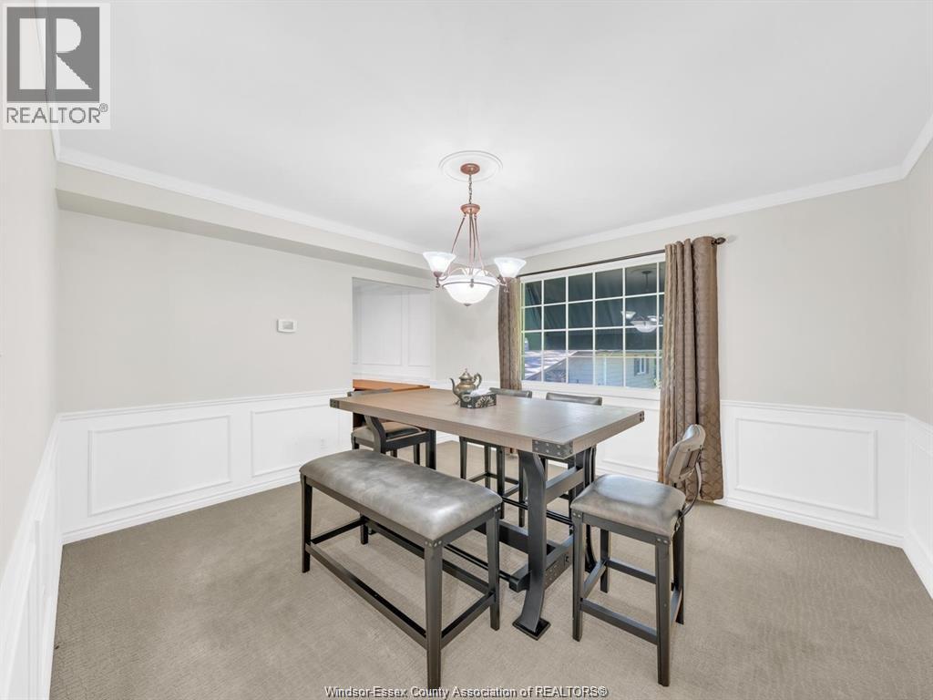 A dining room with a table and chairs.
