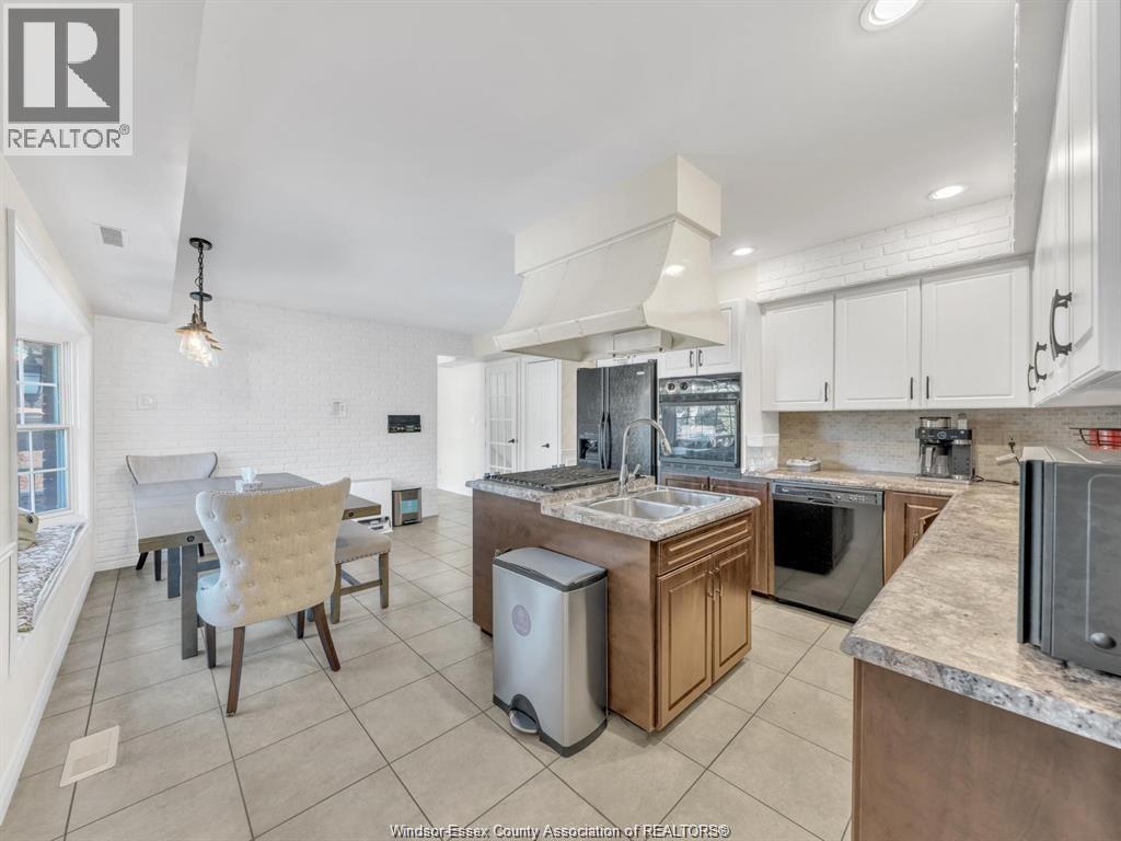 A kitchen with a dining table and chairs.