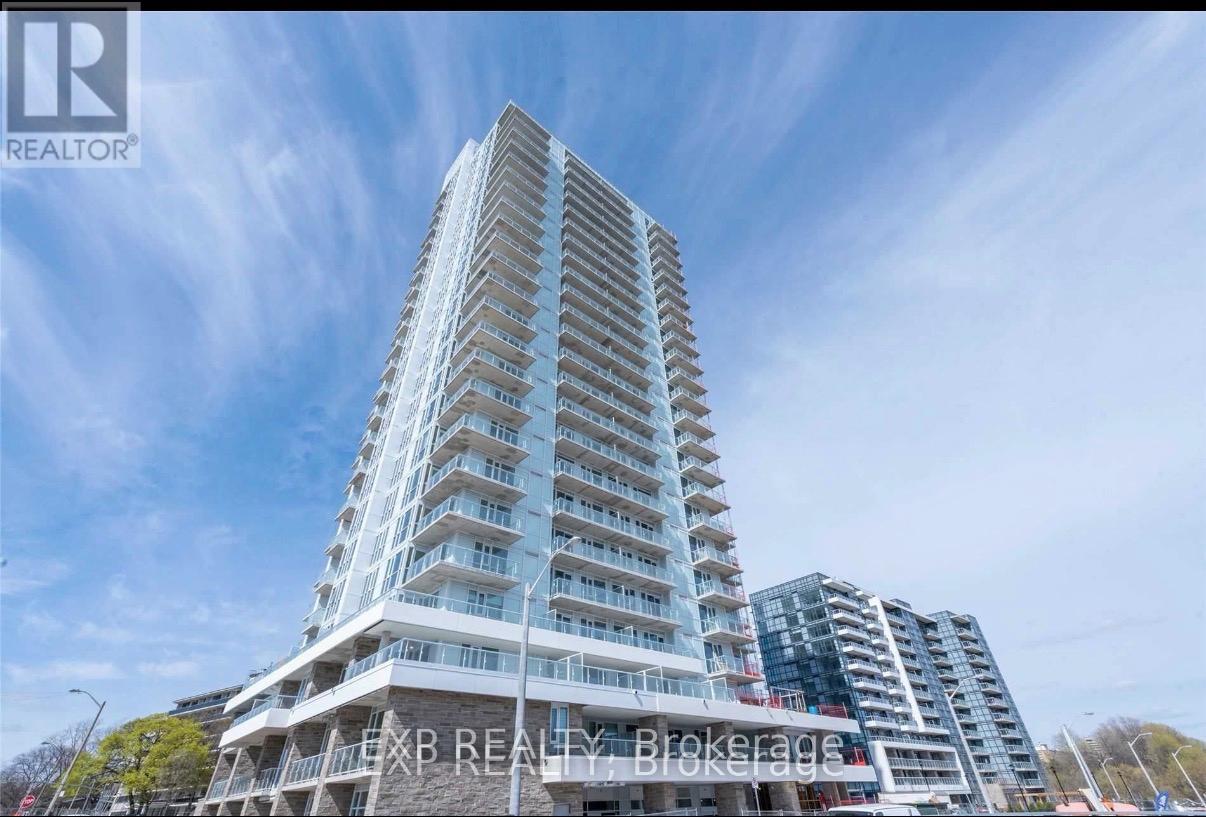 A tall residential building with balconies on the upper floors.