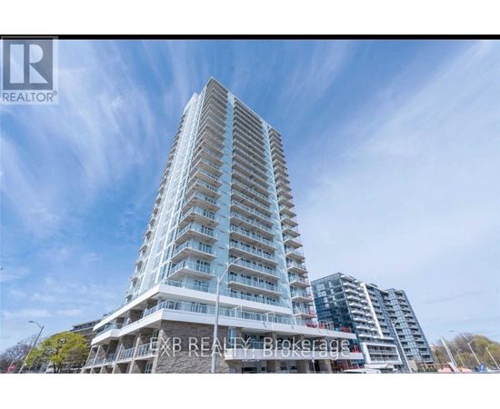 A tall residential building with balconies on the upper floors.