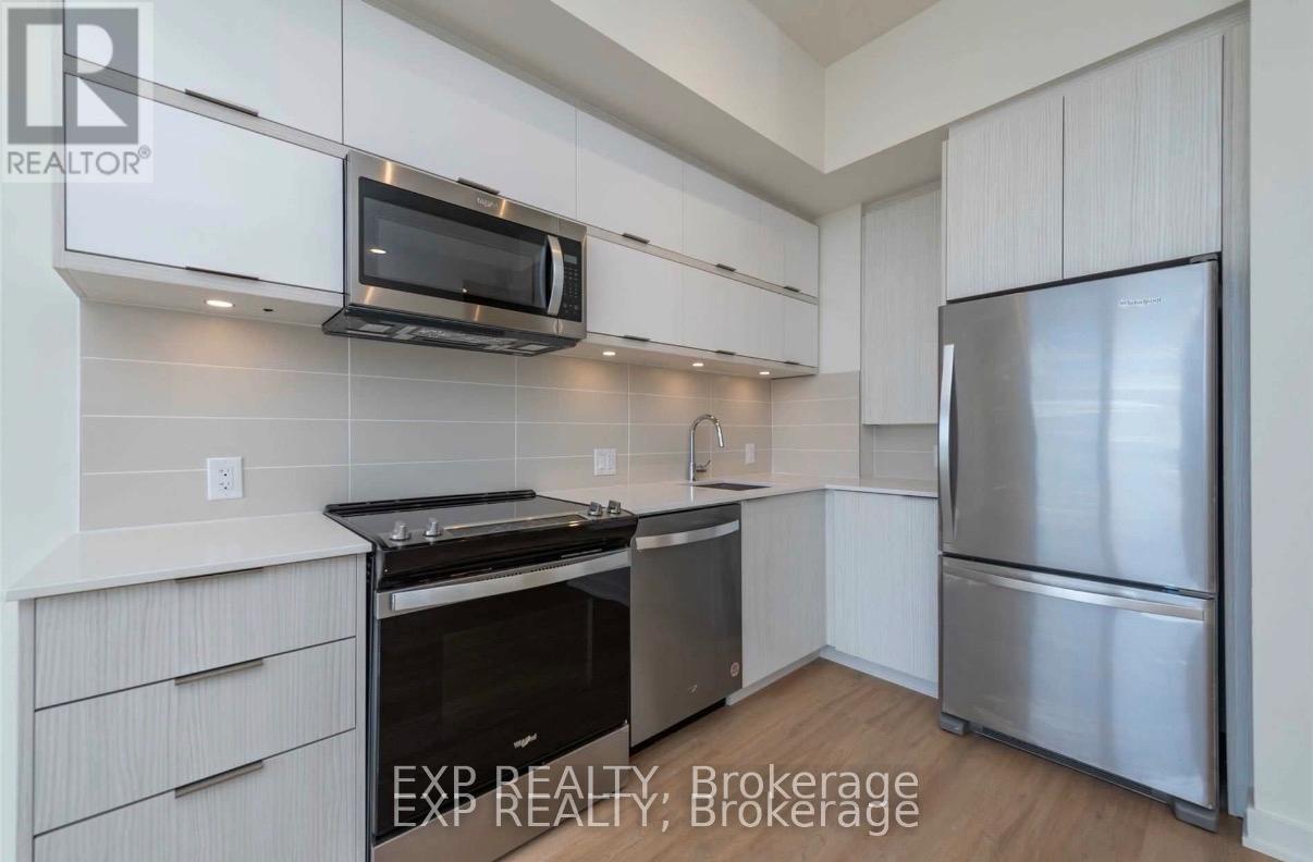 A kitchen with white cabinets and stainless steel appliances.