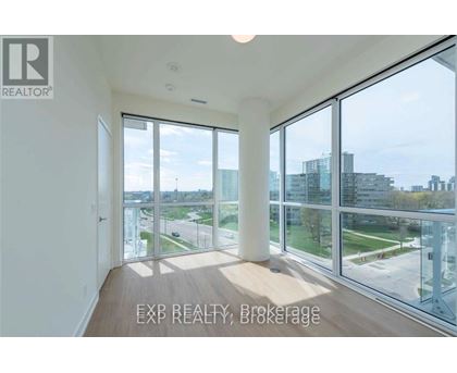 A room with a view of the cityscape through large windows.