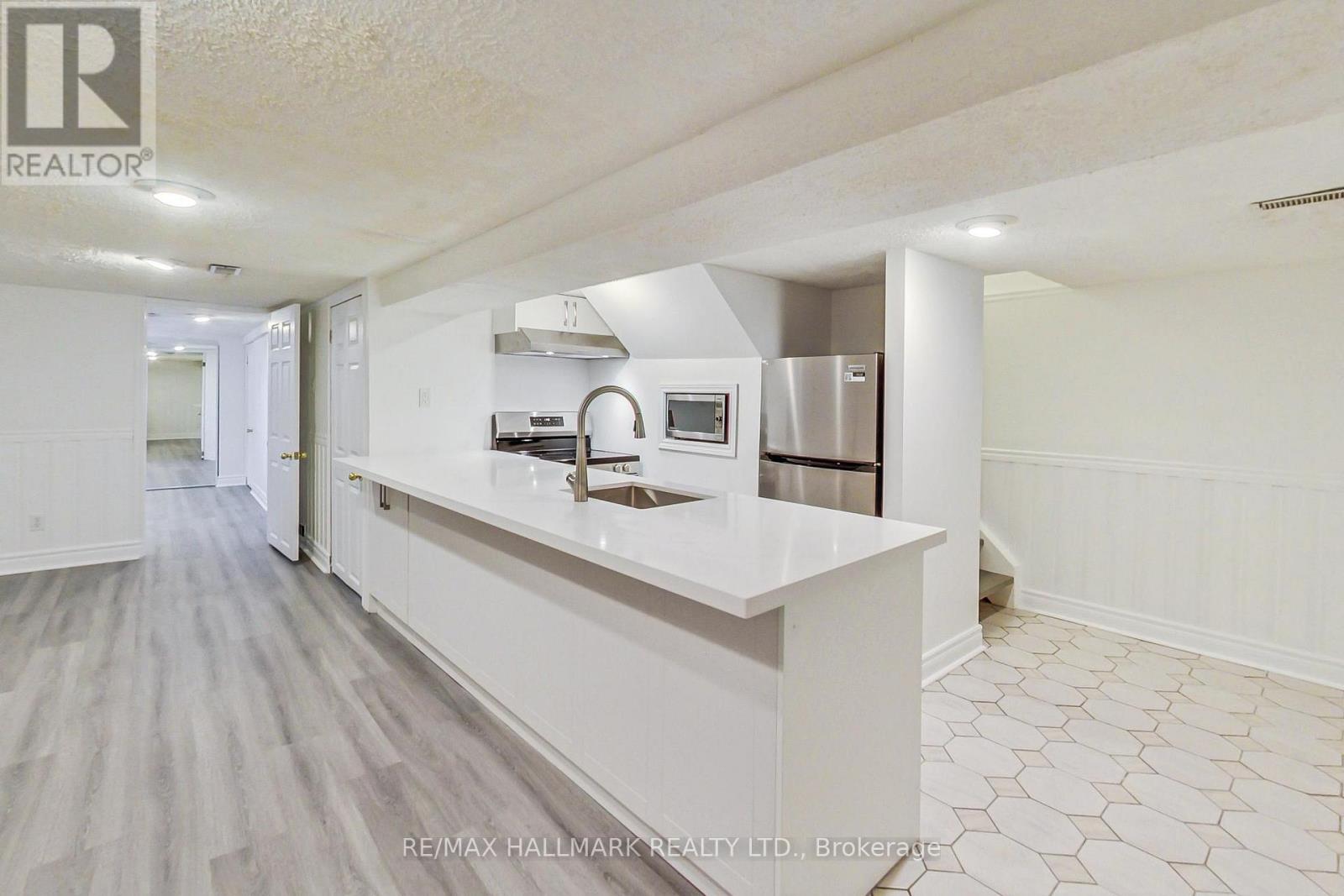 A kitchen with white cabinets and a countertop.