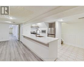 A kitchen with white cabinets and a countertop.