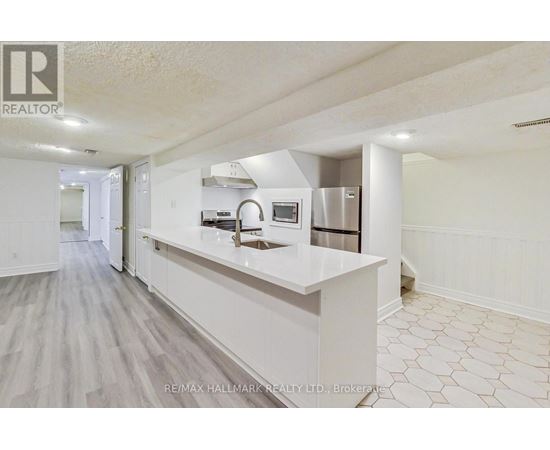 A kitchen with white cabinets and a countertop.