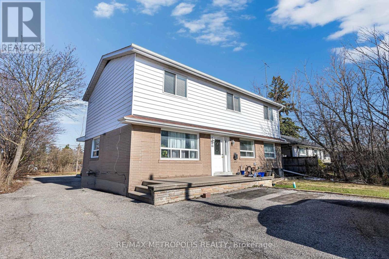 A two-story house with a garage is for sale.
