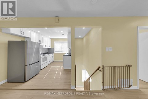 A kitchen with a refrigerator, oven, and sink is shown in a real estate listing.