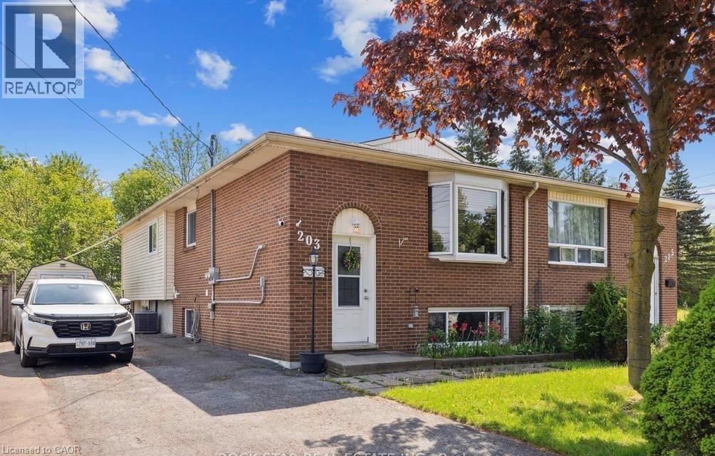 A house with a white door and windows is for sale.