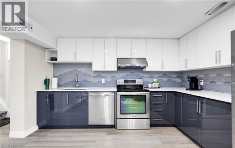 A modern kitchen with a stainless steel dishwasher and oven.
