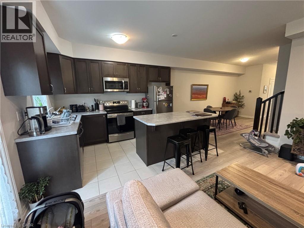 A modern kitchen with dark brown cabinets and a central island.