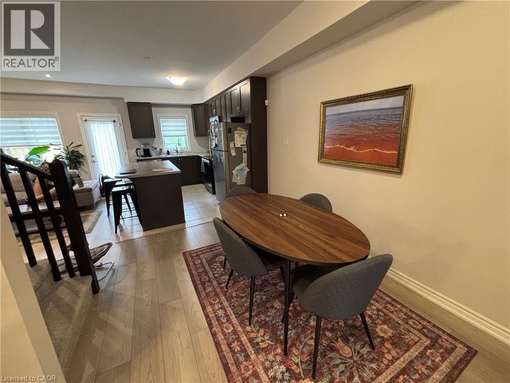 A dining room with a wooden table and chairs.