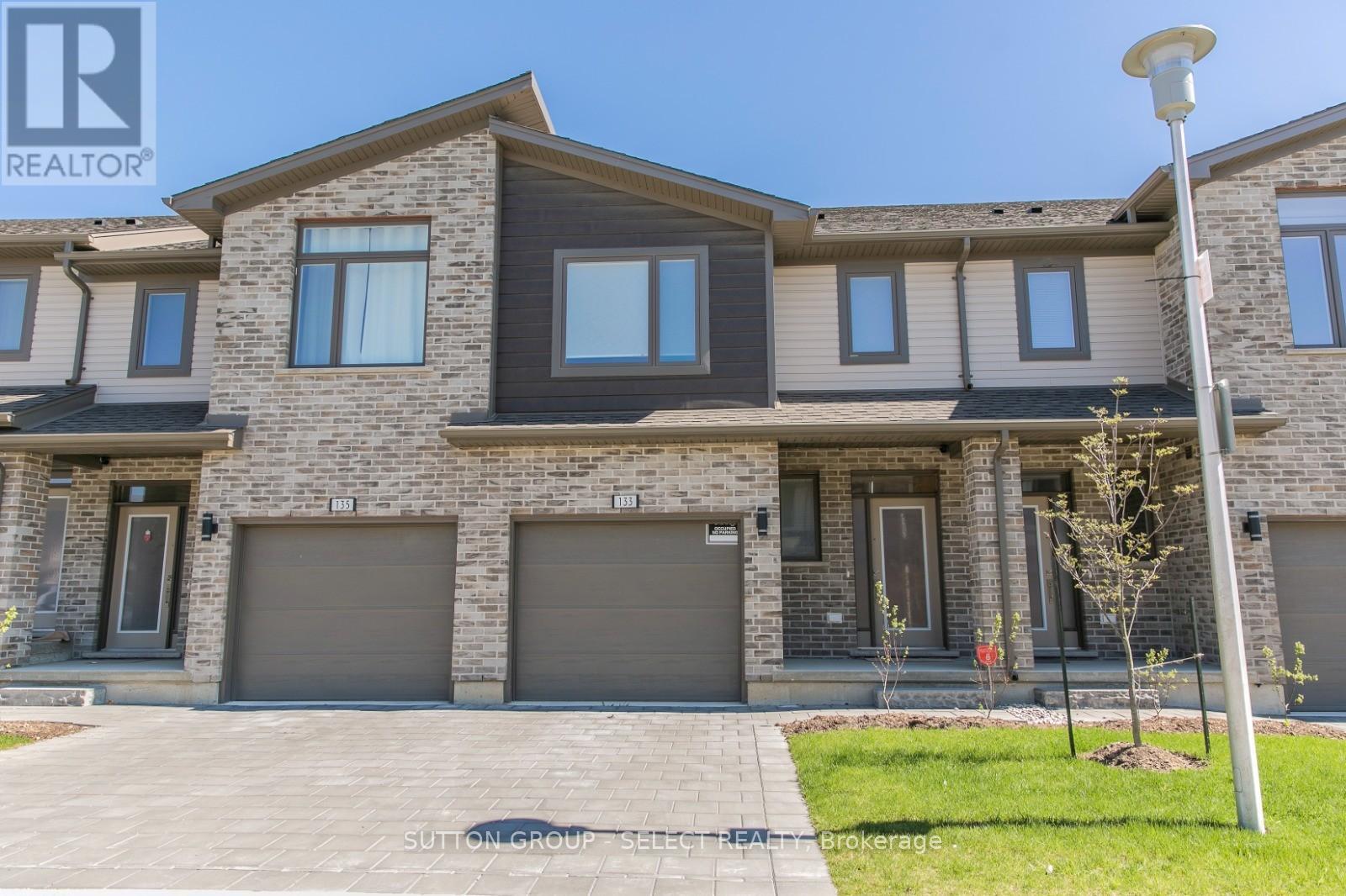 A modern two-story house with a garage and a driveway.