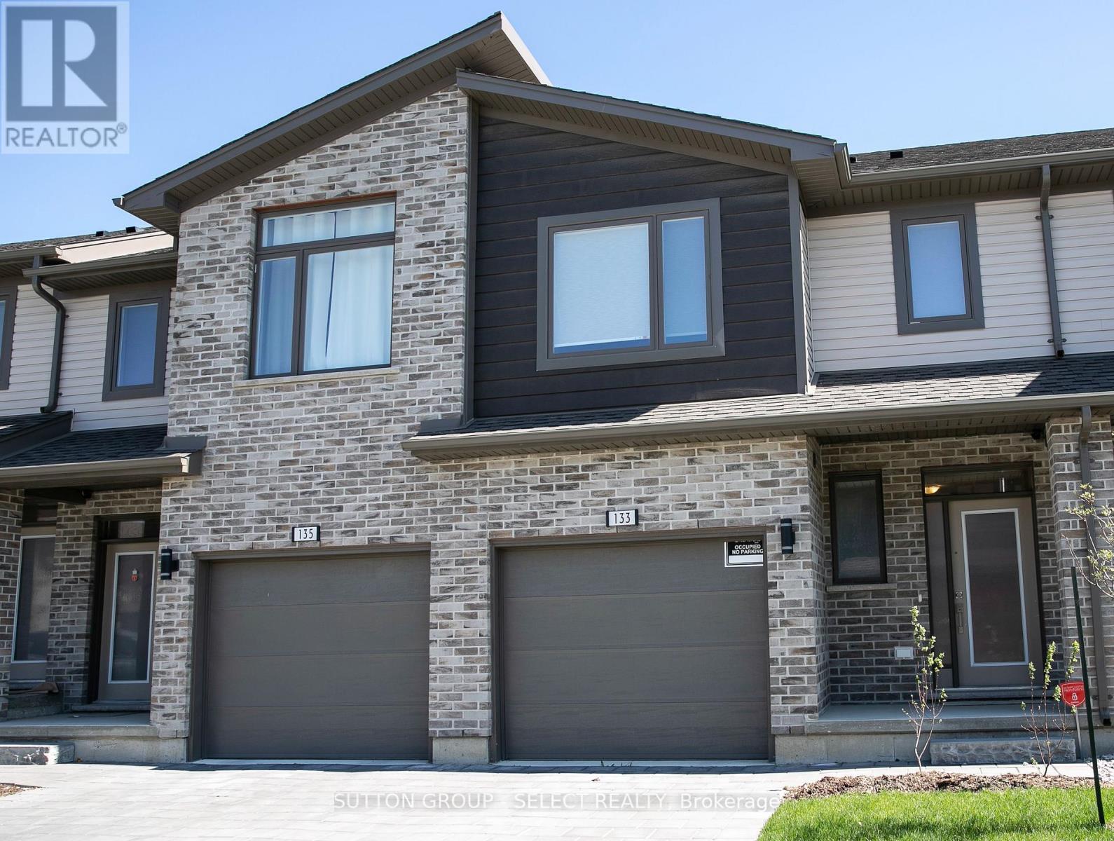 A modern two-story house with a garage on the ground floor.