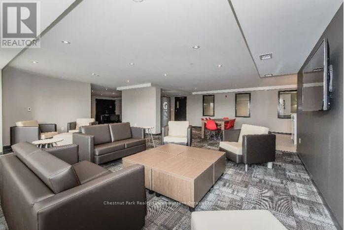 A living room with a brown couch and a television.