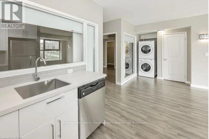 A modern kitchen with a sink, stove, and dishwasher.