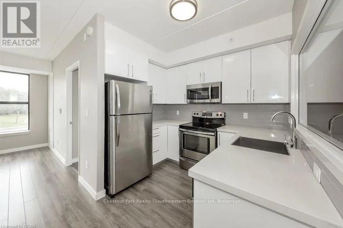 A modern kitchen with stainless steel appliances and white cabinets.