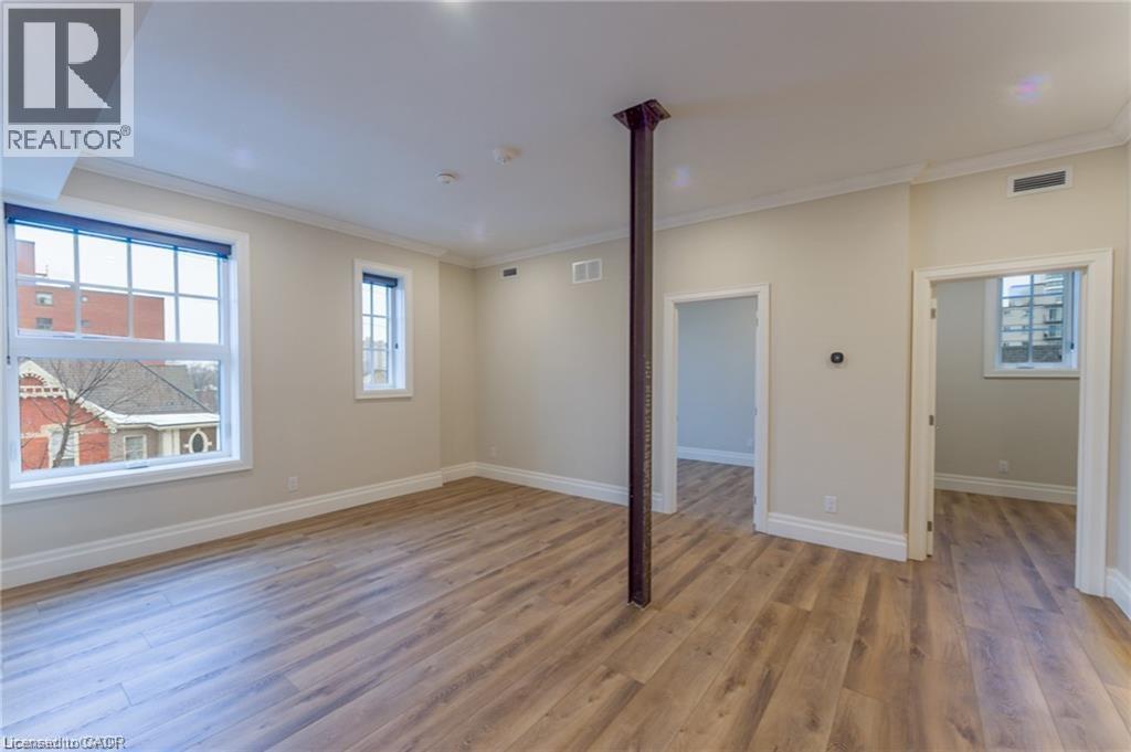 A room with wooden floors and a large window.