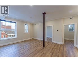 A room with wooden floors and a large window.