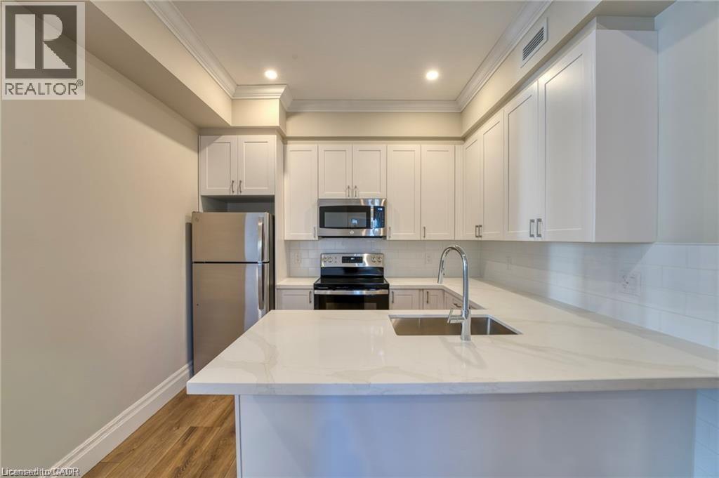A modern kitchen with white cabinets and a white countertop.
