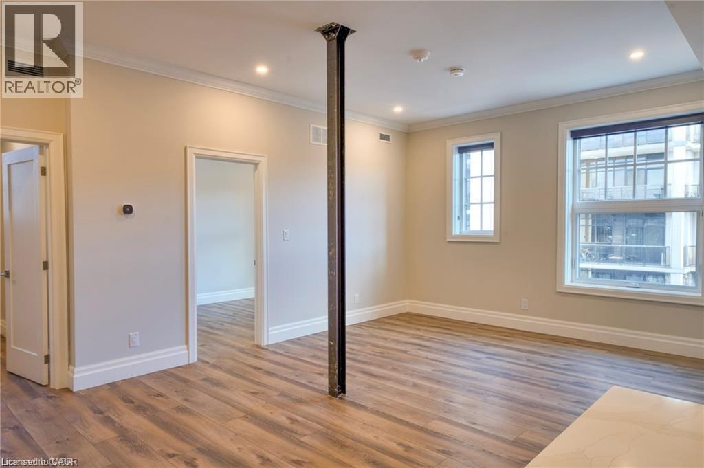 A room with wooden floors and a large window.