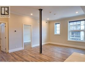 A room with wooden floors and a large window.