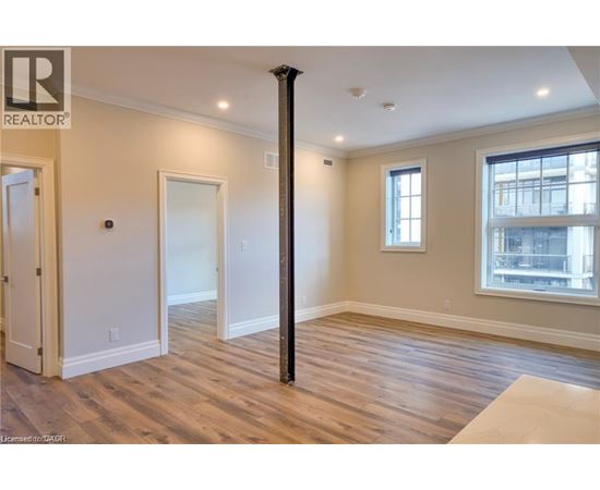 A room with wooden floors and a large window.