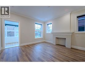 A spacious living room with a fireplace and hardwood floors.