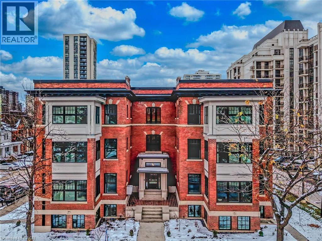 A large red brick building with a balcony in the center.