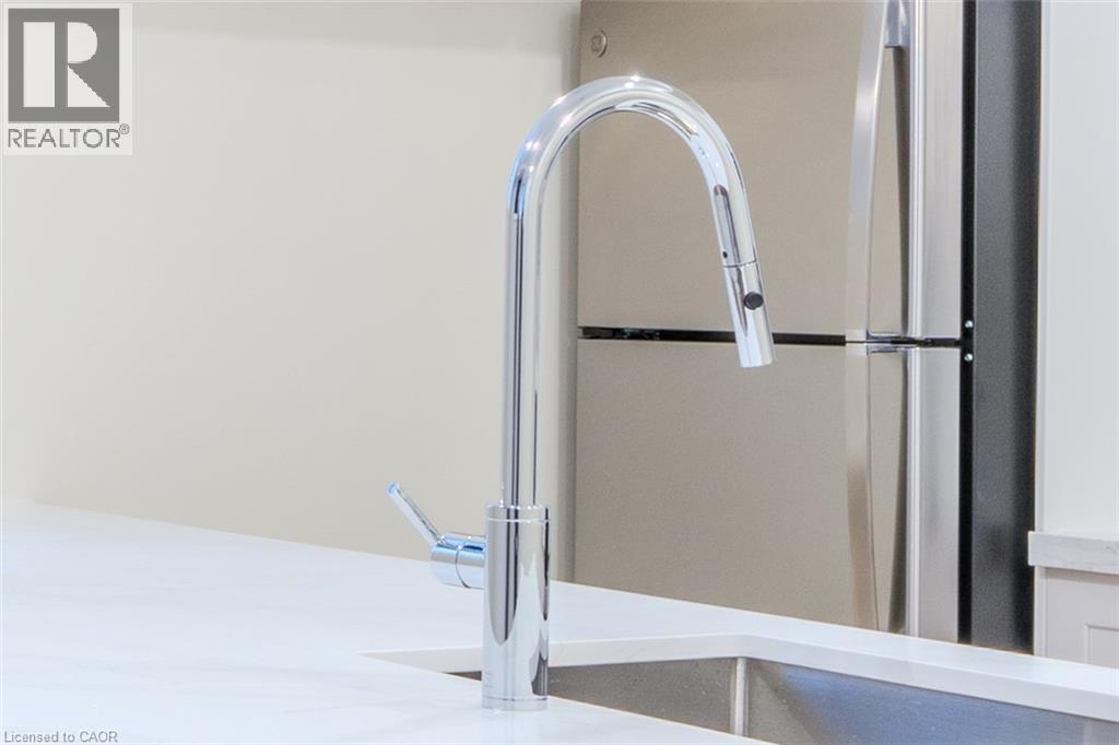 A modern kitchen sink with a chrome faucet.