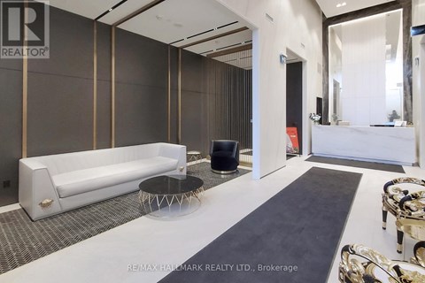 A modern living room with a white sofa and a black coffee table.