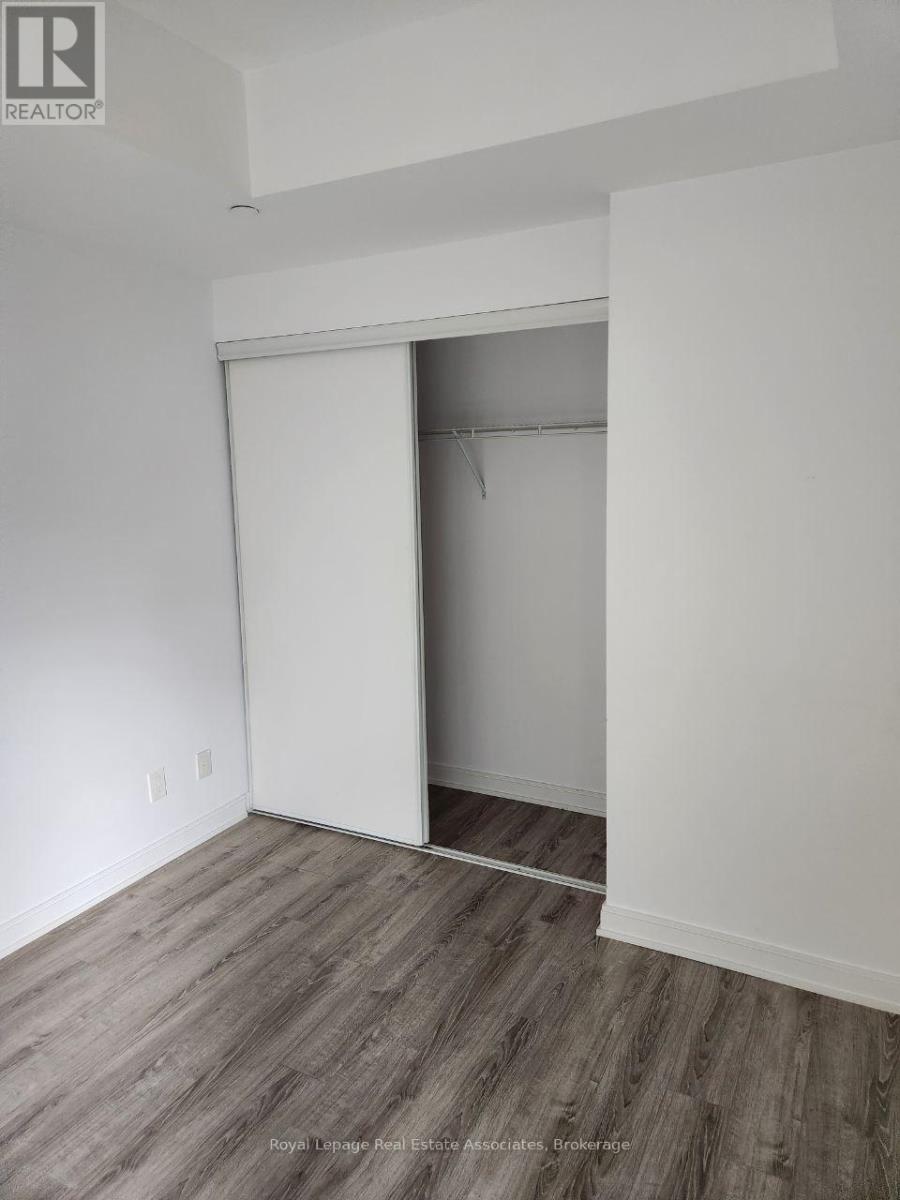 A room with a sliding door and wood flooring.