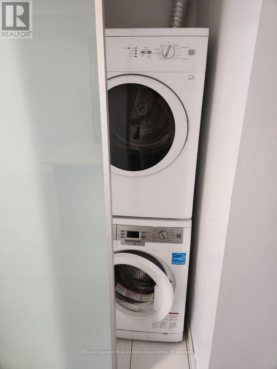 A white front loading washing machine with a blue label on the door.