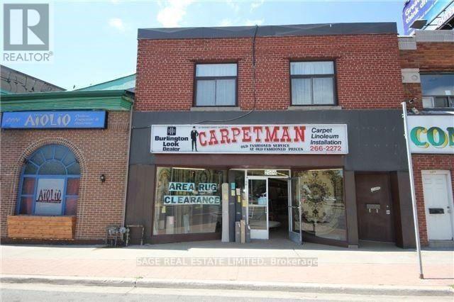 A carpet store with a sign that says "Area Rug Clearance".