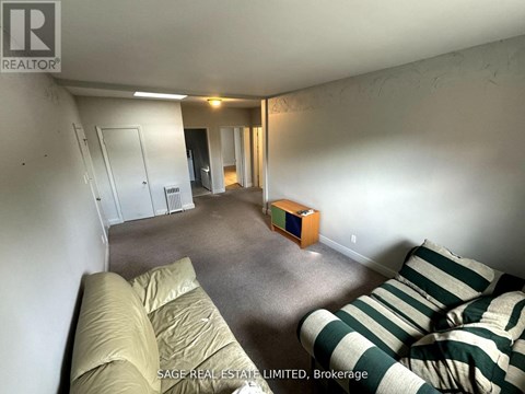 A living room with a couch and a box on the floor.