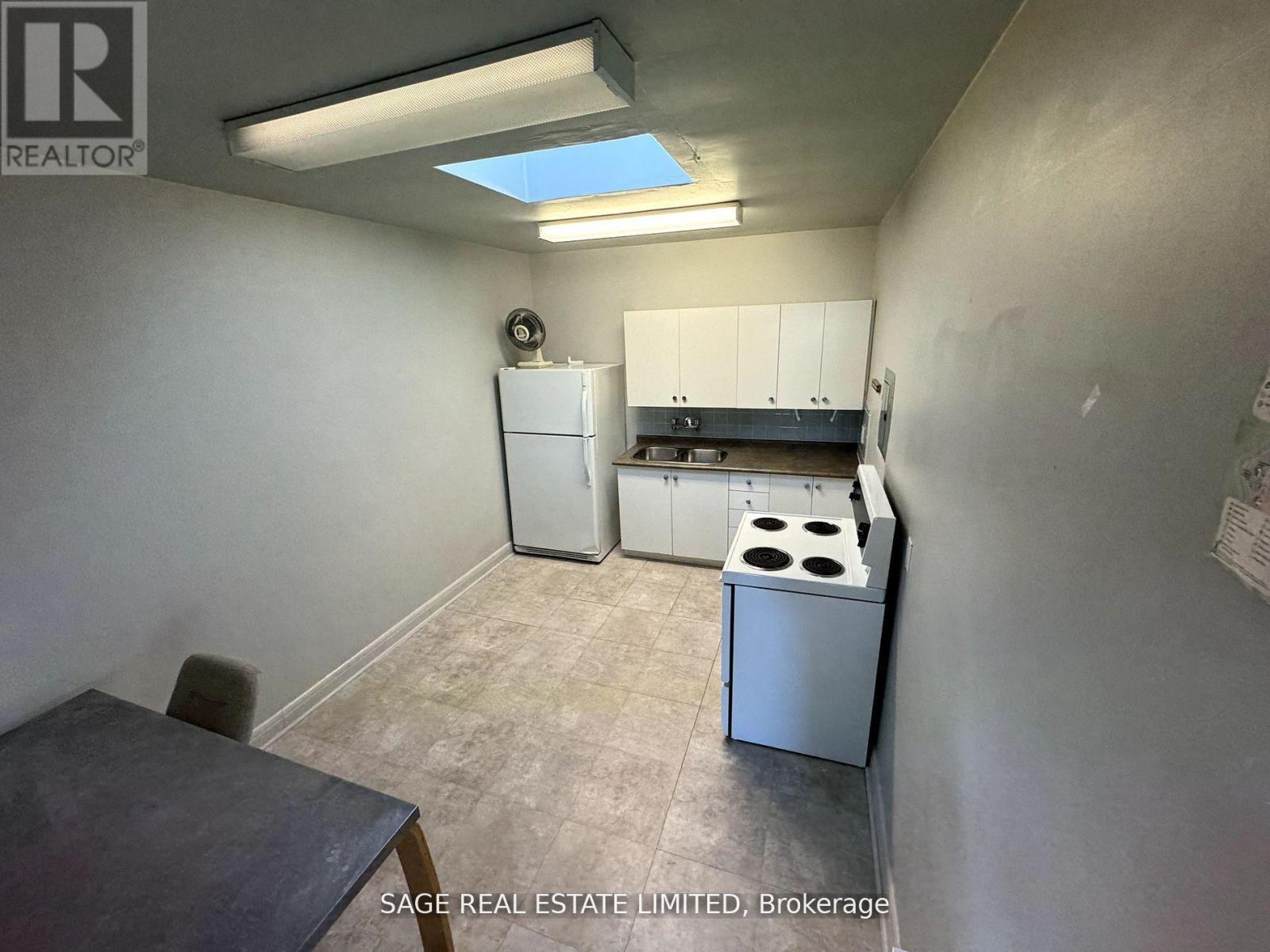 A small kitchen with a stove and a refrigerator.