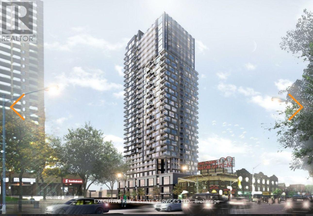 A tall building with many windows is the main focus of the image.