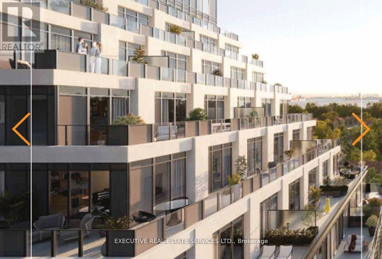 A modern apartment building with balconies and a logo that reads "REALTOR".