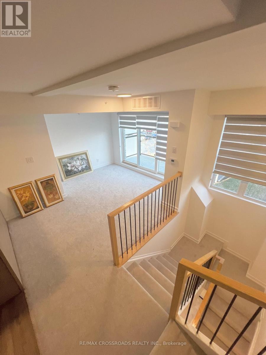 A view from the top of a staircase looking down at a living room.