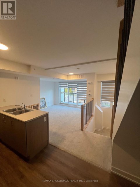 A kitchen with a sink and a window.