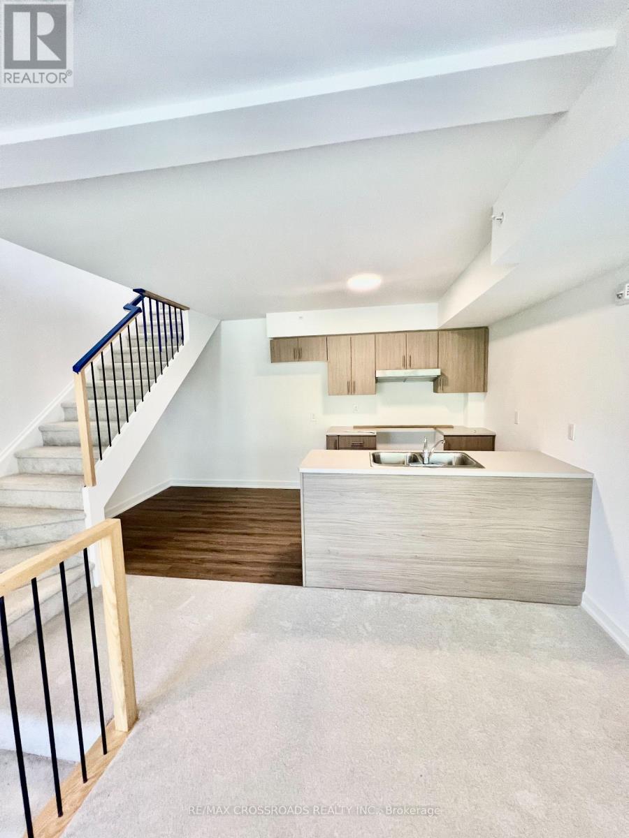A modern interior space with a staircase leading to the upper level.