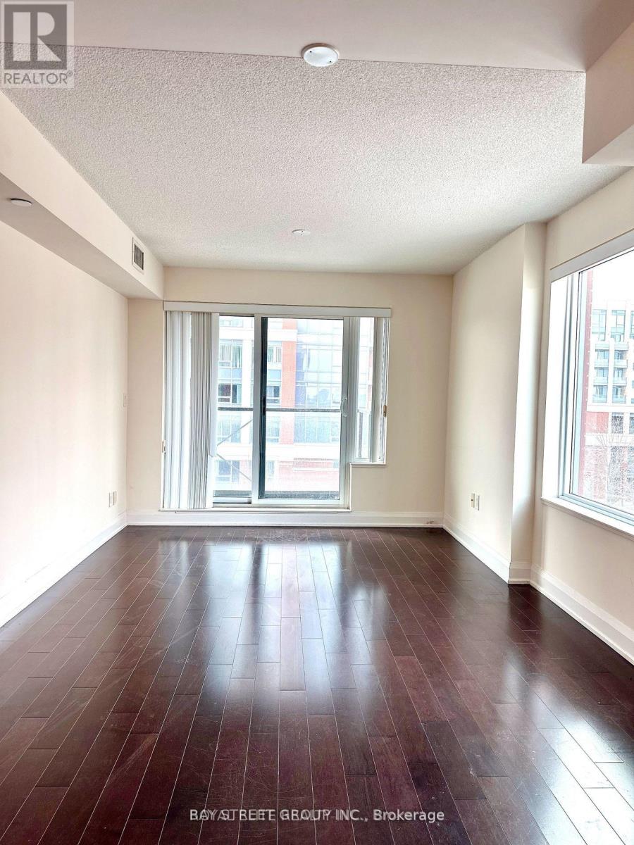A spacious room with a view of the city through the windows.