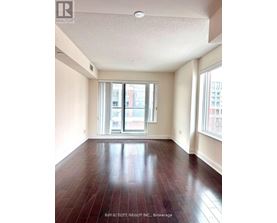 A spacious room with a view of the city through the windows.