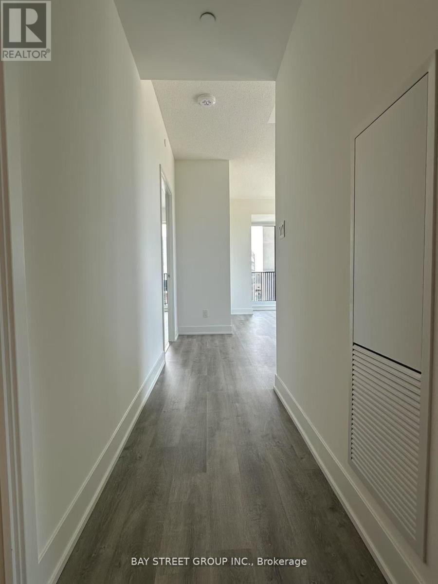 A long hallway with a bay street group inc brokerage sign.