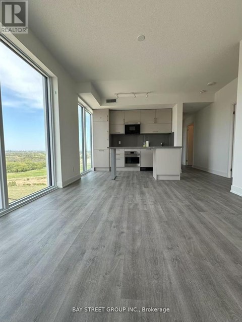 A spacious kitchen and living room with a view of the outdoors.