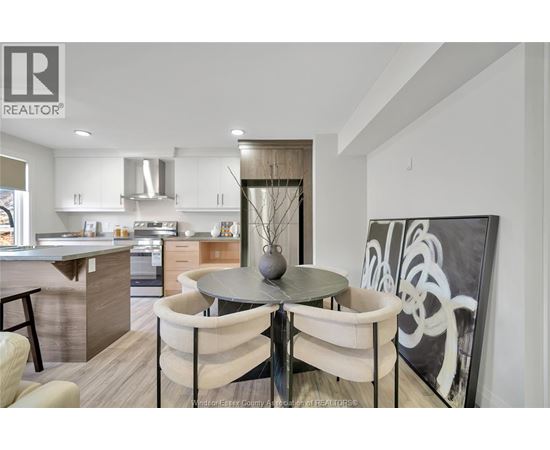 A modern kitchen with a dining table set for two.
