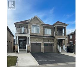 A two-story house with a garage is for sale.