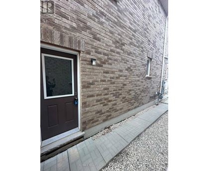 A brown door is on a brick wall.